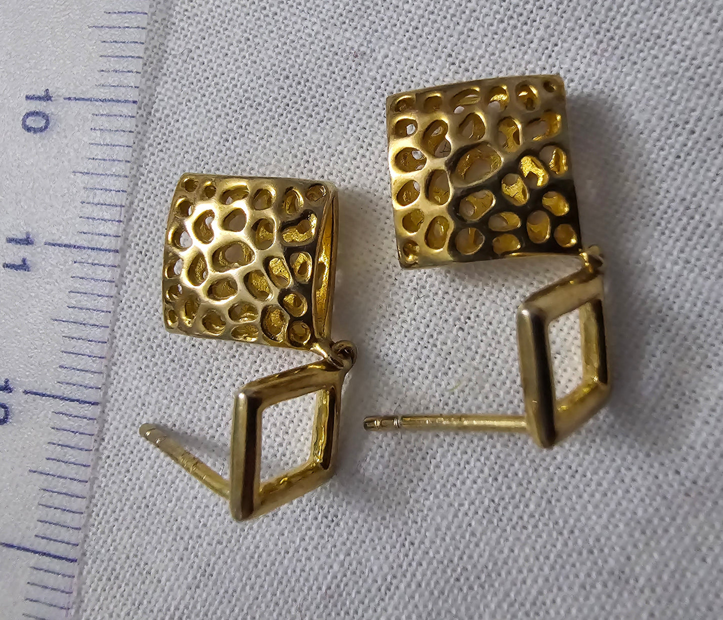 Gold on silver open weave offset square with filligree style drop.